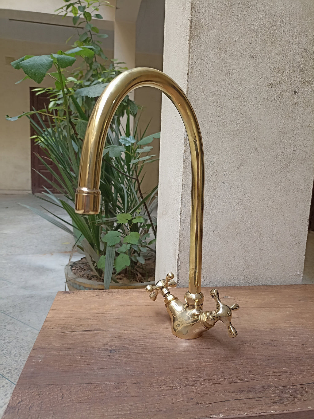 Brass gooseneck kitchen faucet