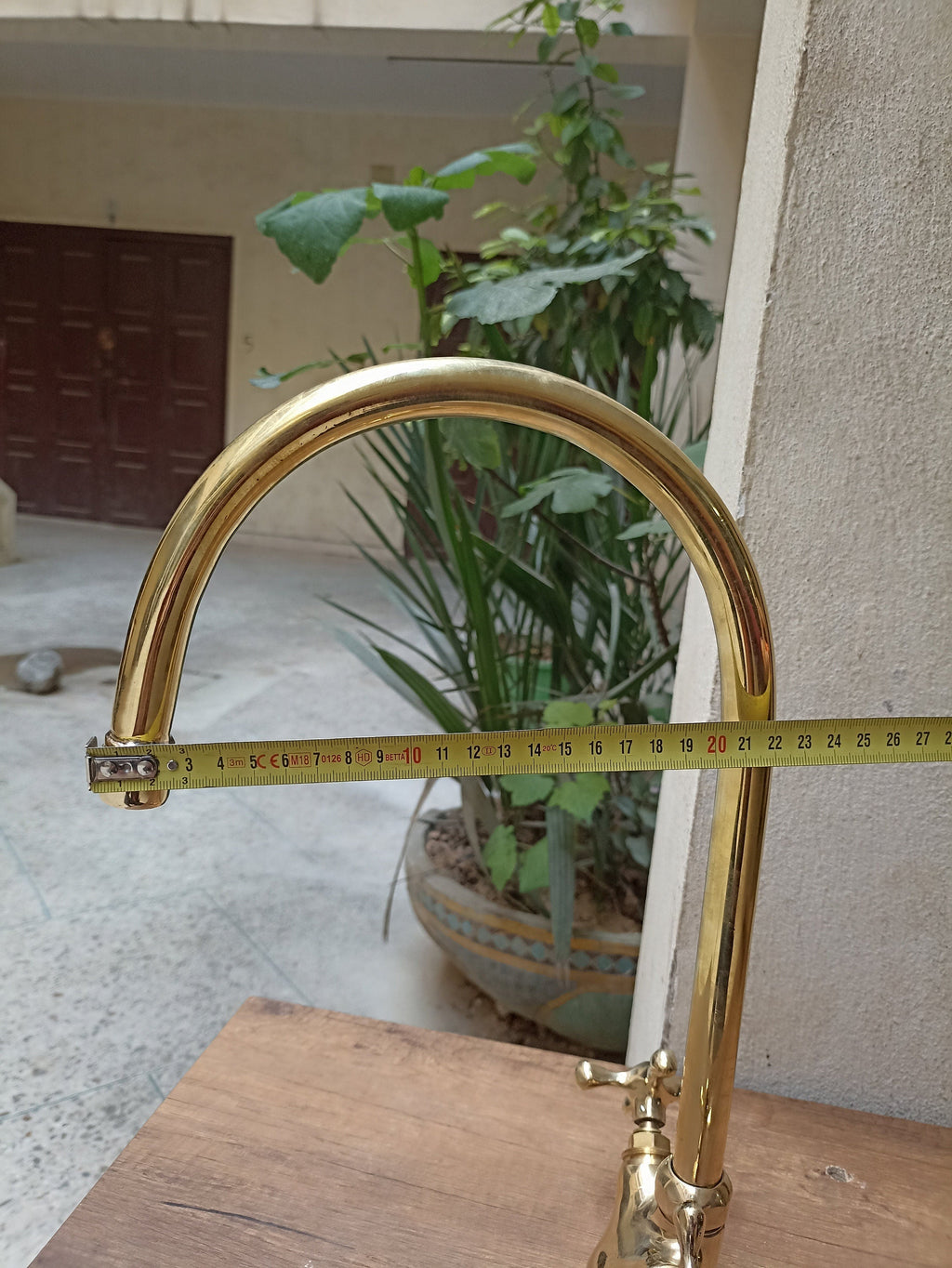 Brass gooseneck kitchen faucet