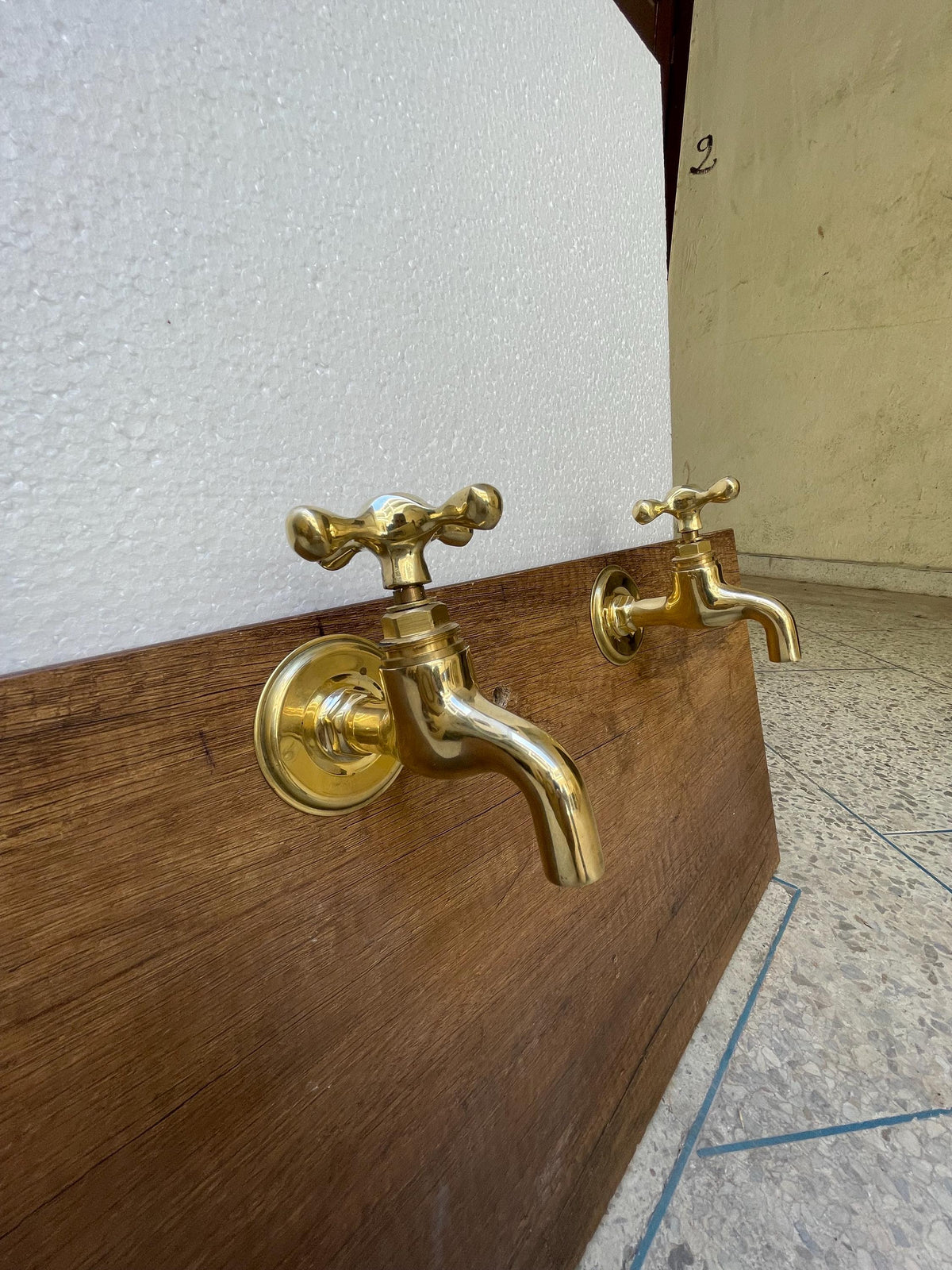 Unlacquered brass wall faucets - Unlacquered plain end faucet.