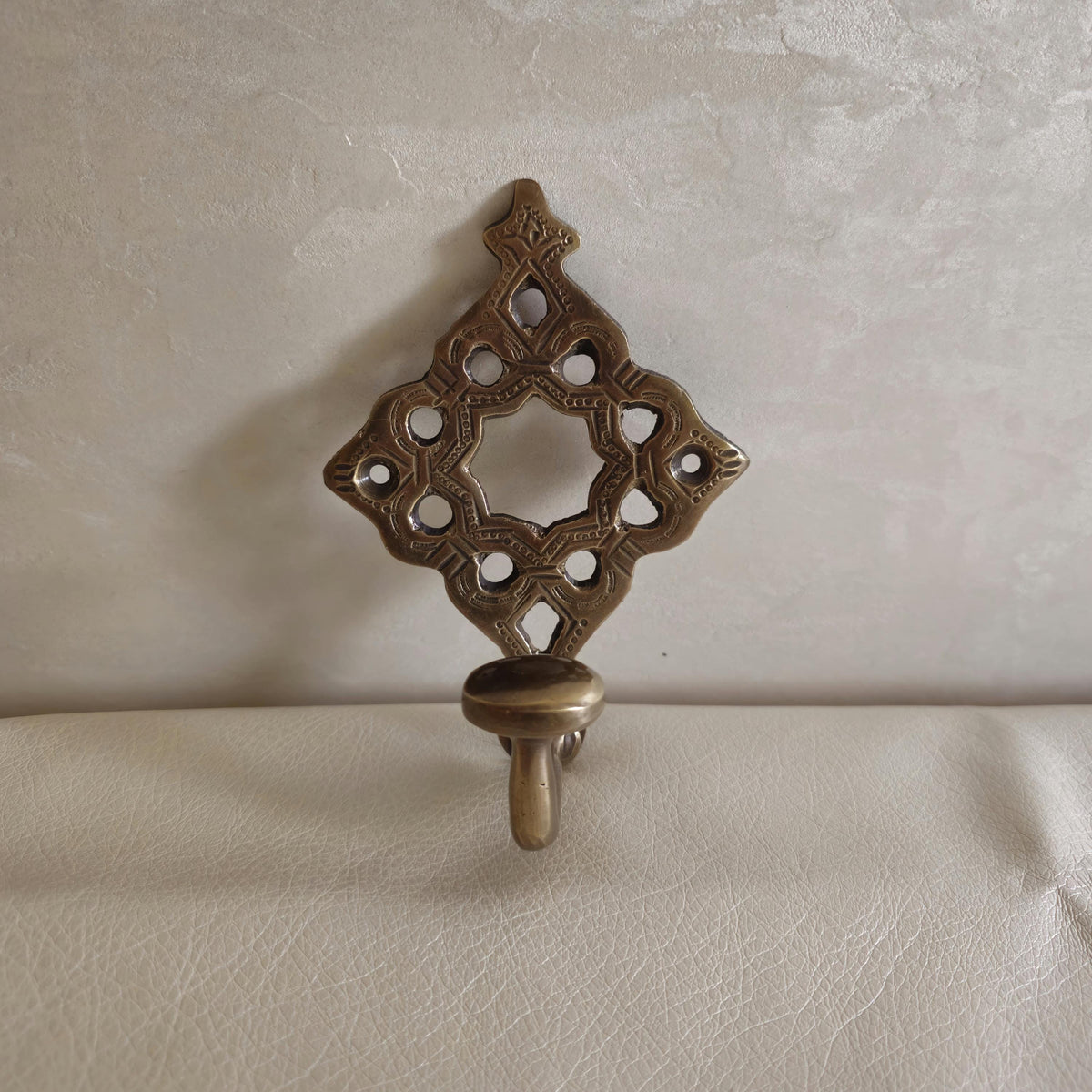 Pierced brass wall hook