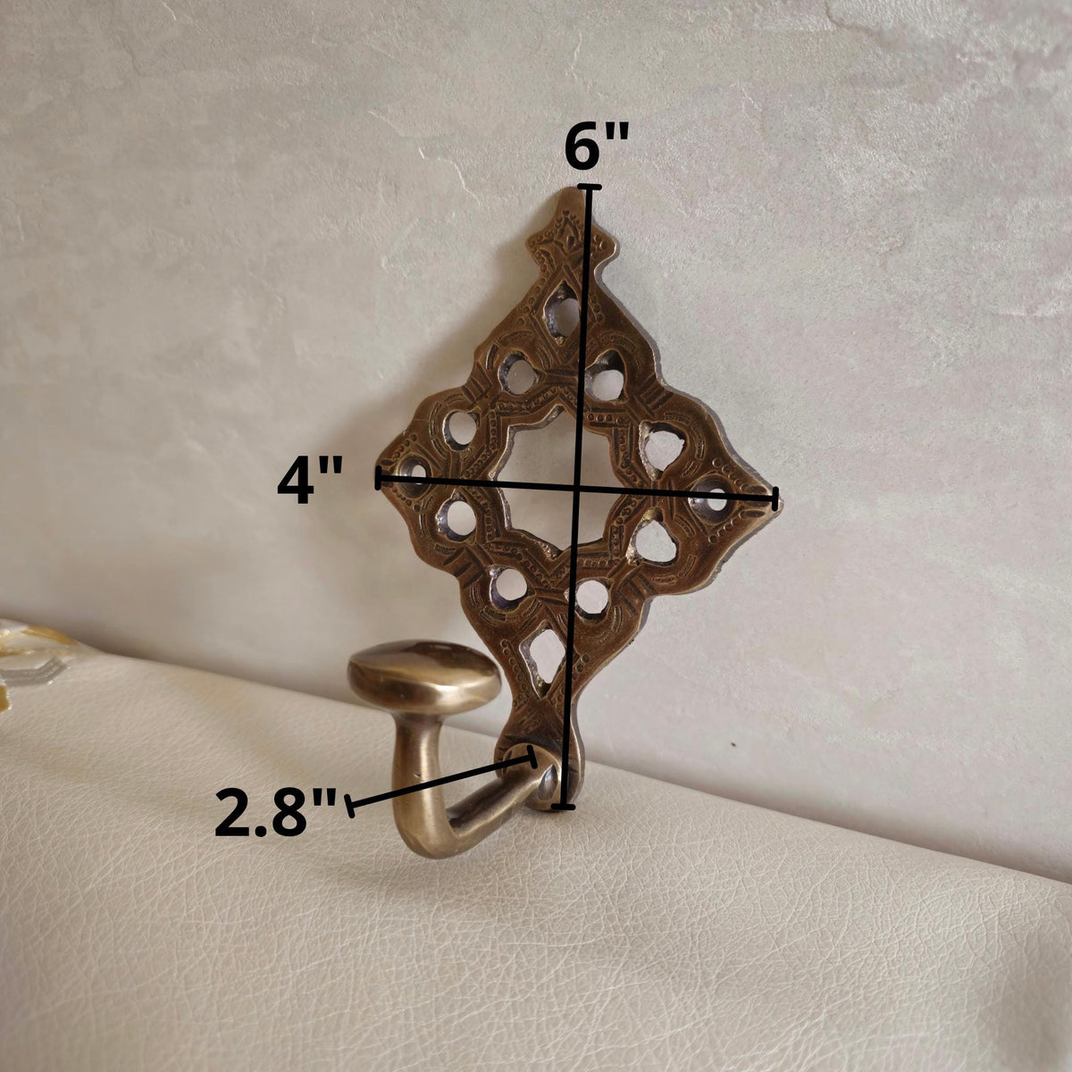 Pierced brass wall hook