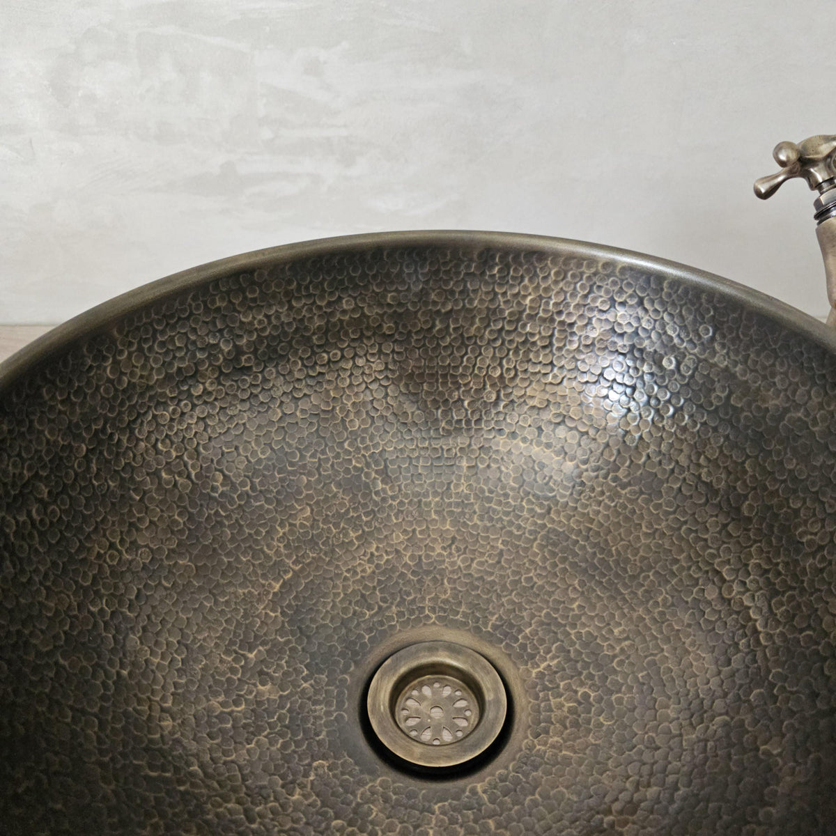 Hand-hammered patinated brass sink