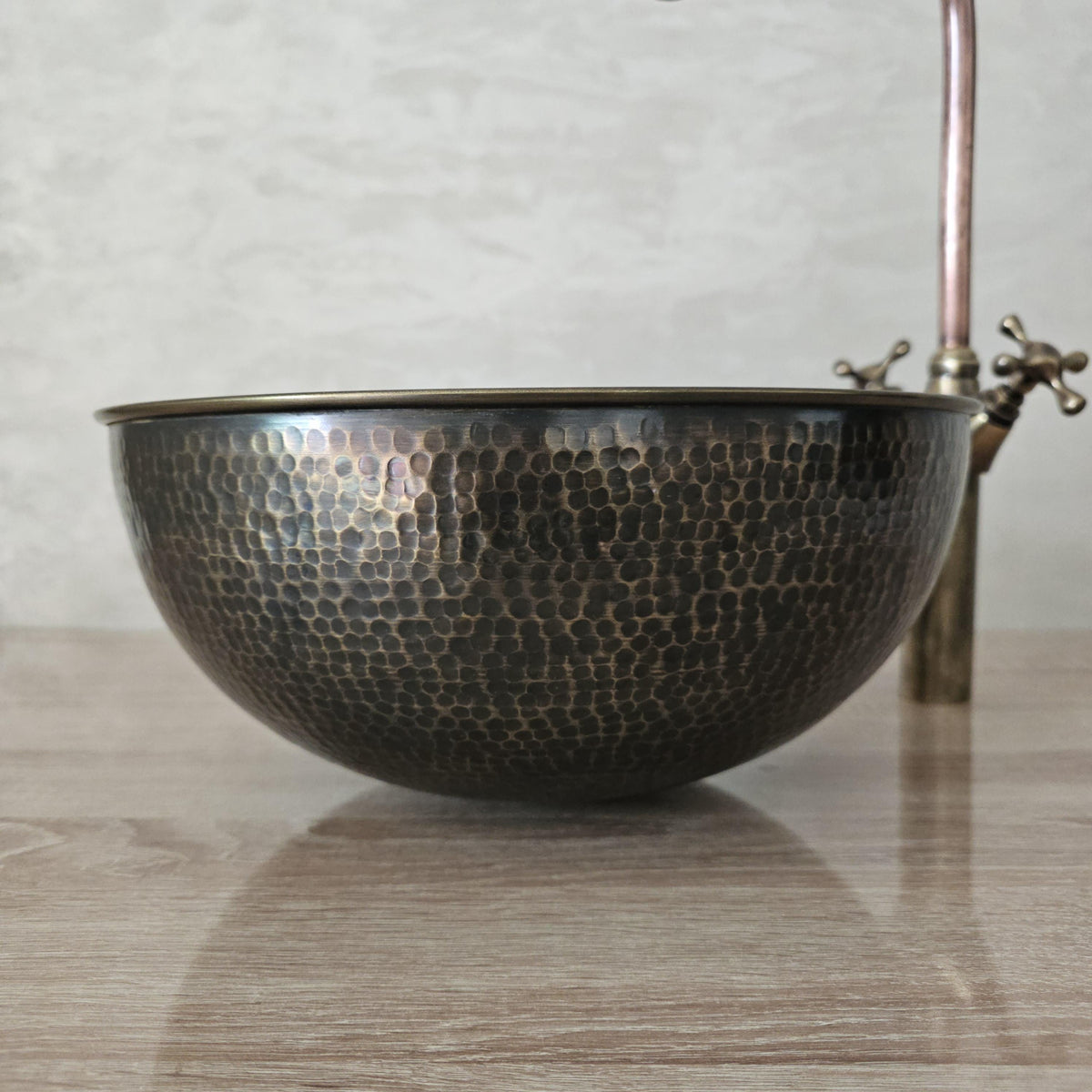 Hand-hammered patinated brass sink