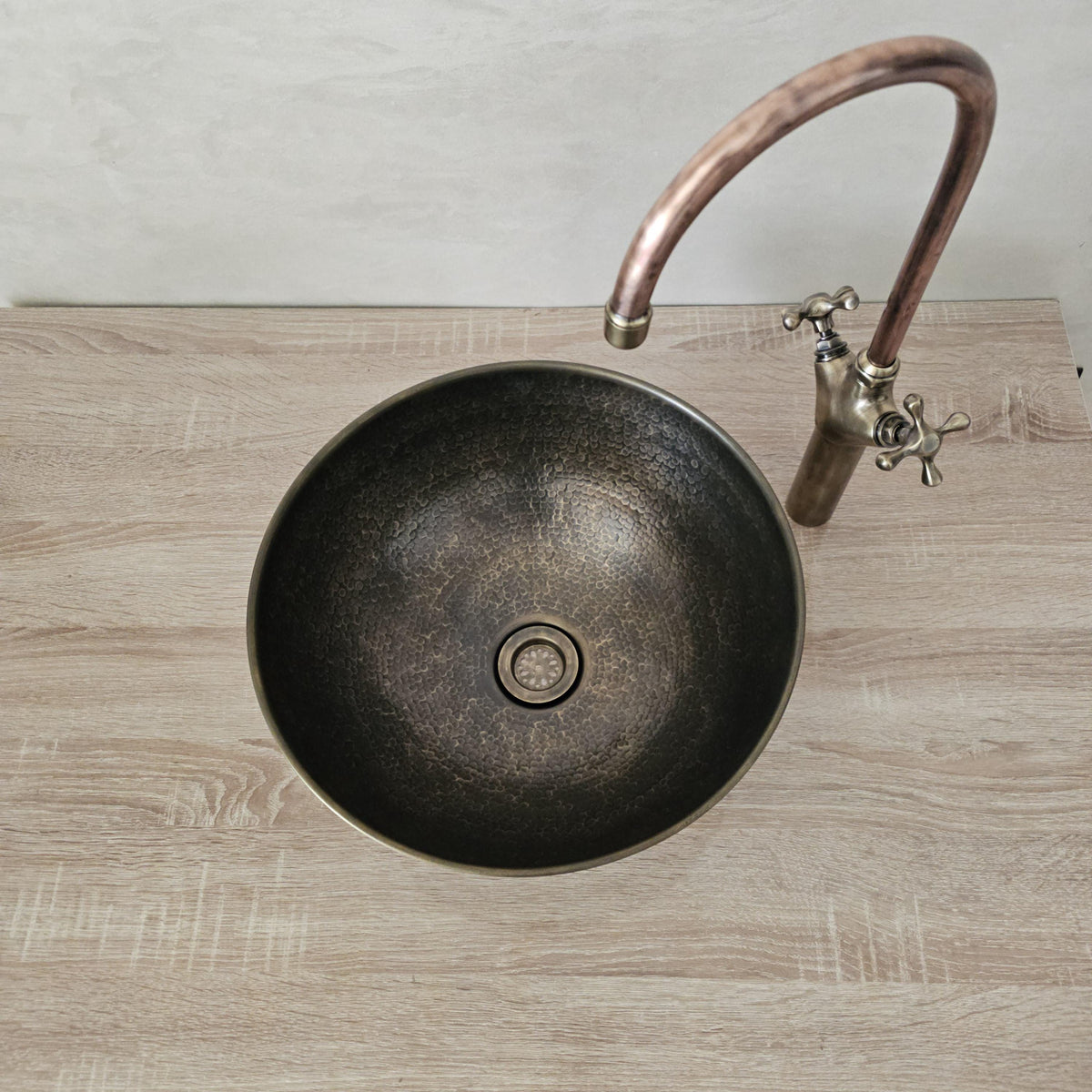 Hand-hammered patinated brass sink