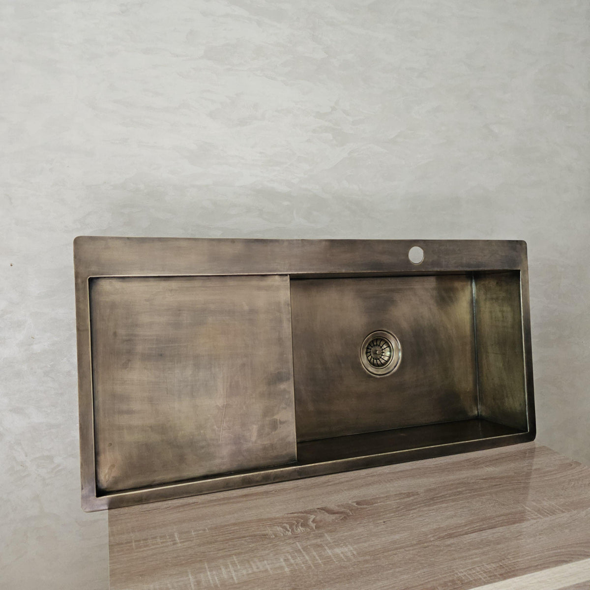 Brass sink with integrated drainboard